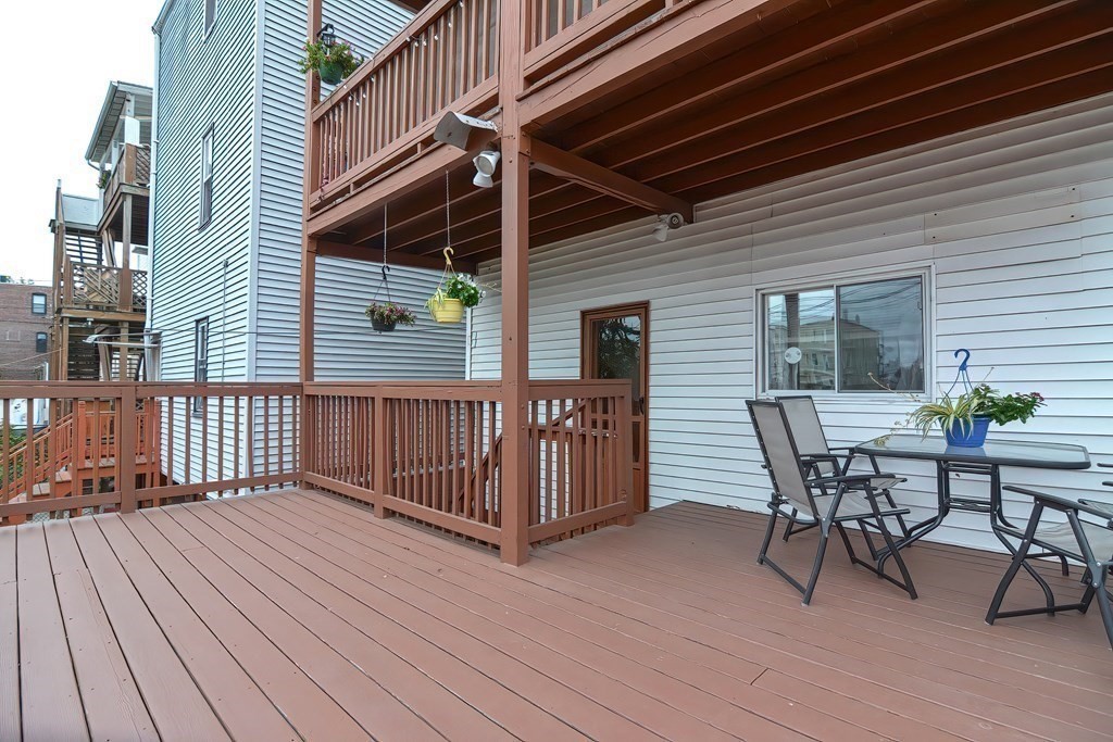 110 Everett Street Boston, MA 02128 - Photo 34 of 41 a view of a roof deck with wooden floor and fence