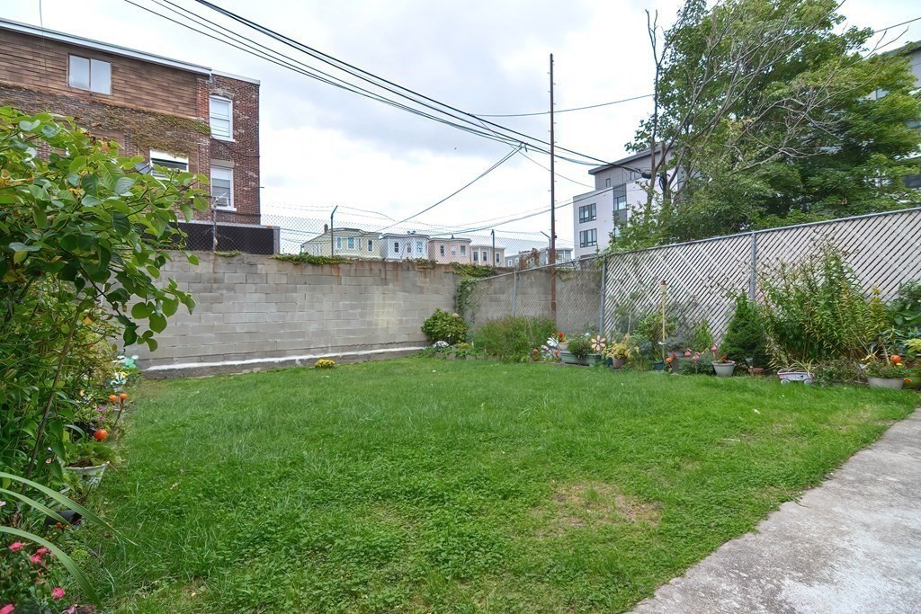 110 Everett Street Boston, MA 02128 - Photo 36 of 41 a view of a backyard with plants and large tree