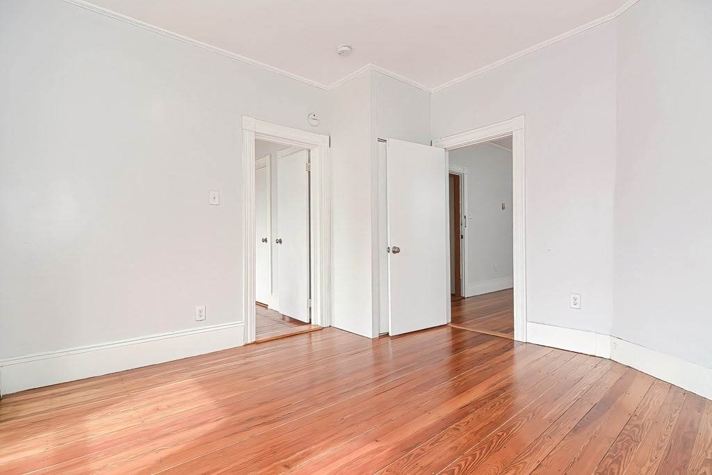 110 Everett Street Boston, MA 02128 - Photo 8 of 41 an empty room with wooden floor