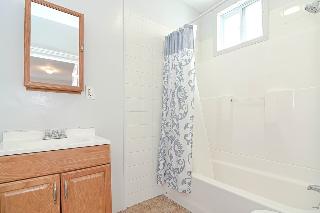 110 Everett Street Boston, MA 02128 - Photo 9 of 41 a bathroom with a shower curtain and a window