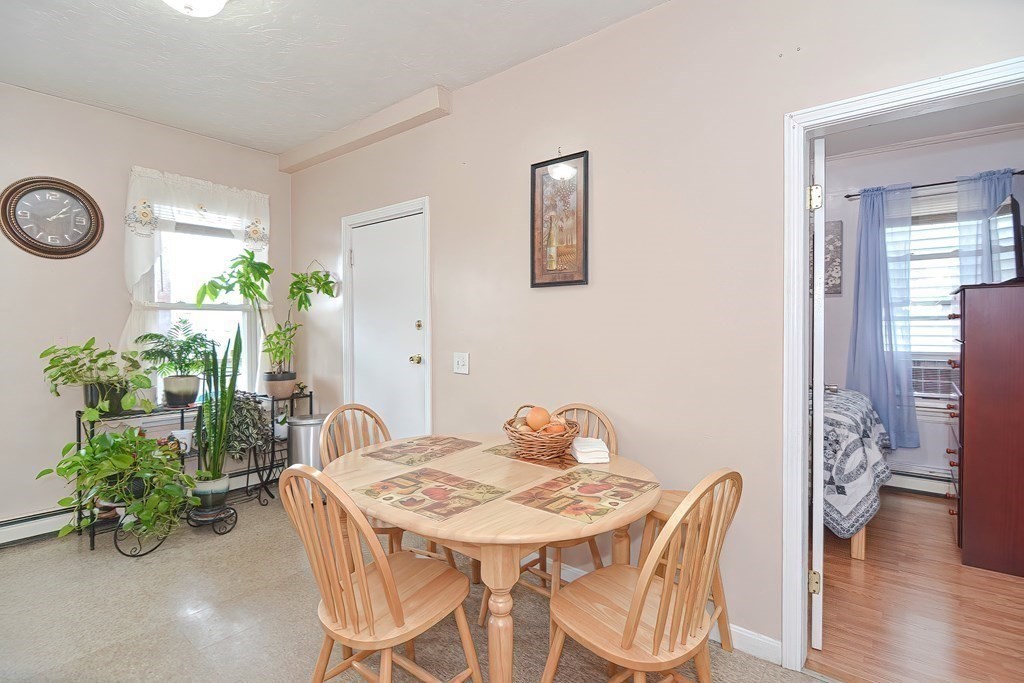 110 Everett Street Boston, MA 02128 - Photo 10 of 41 a view of a dining room with furniture and wooden floor