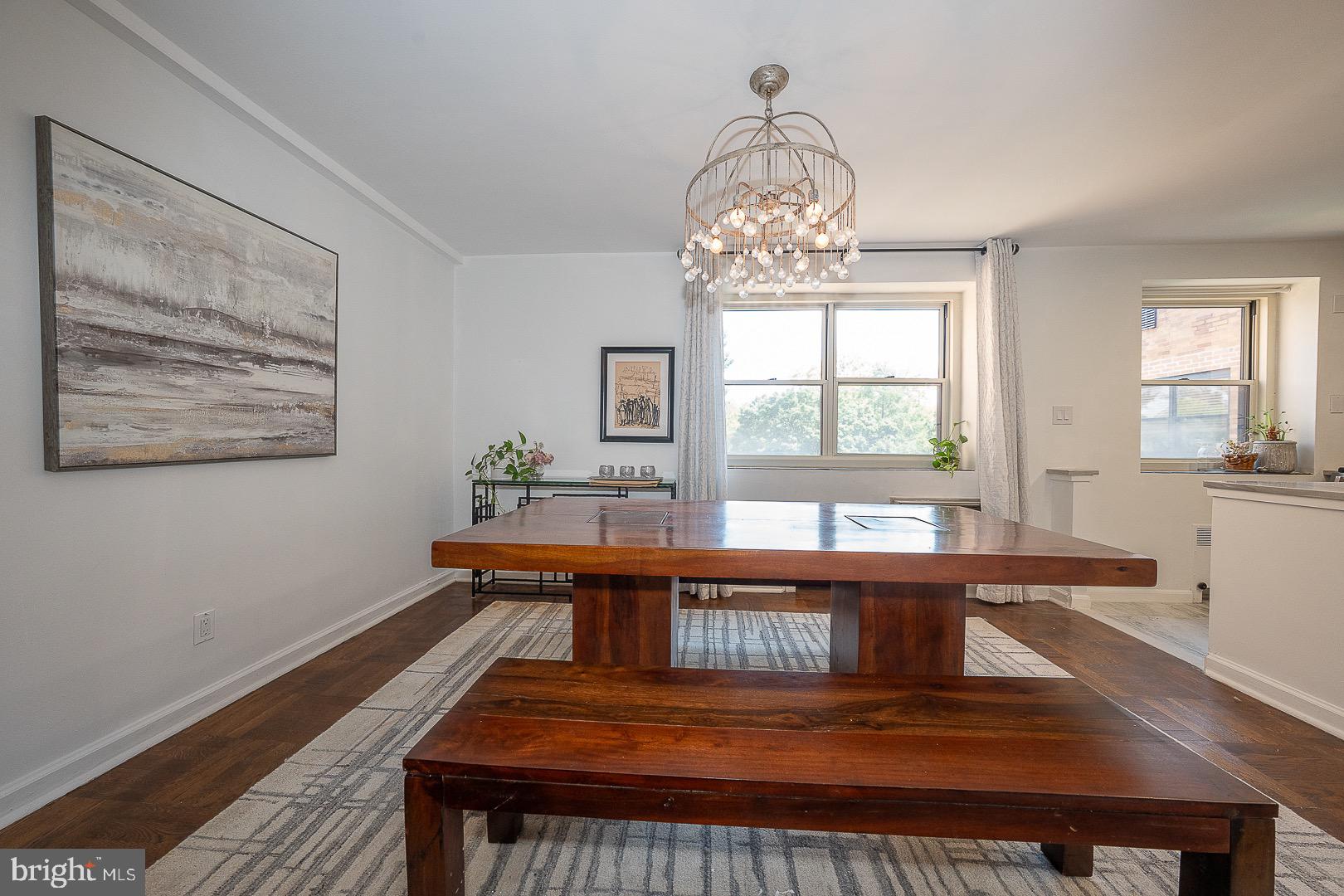 40 Old Lancaster Road, Unit 512 Merion Station, PA 19066 - Photo 16 of 60 a view of a dining room with furniture a chandelier and wooden floor