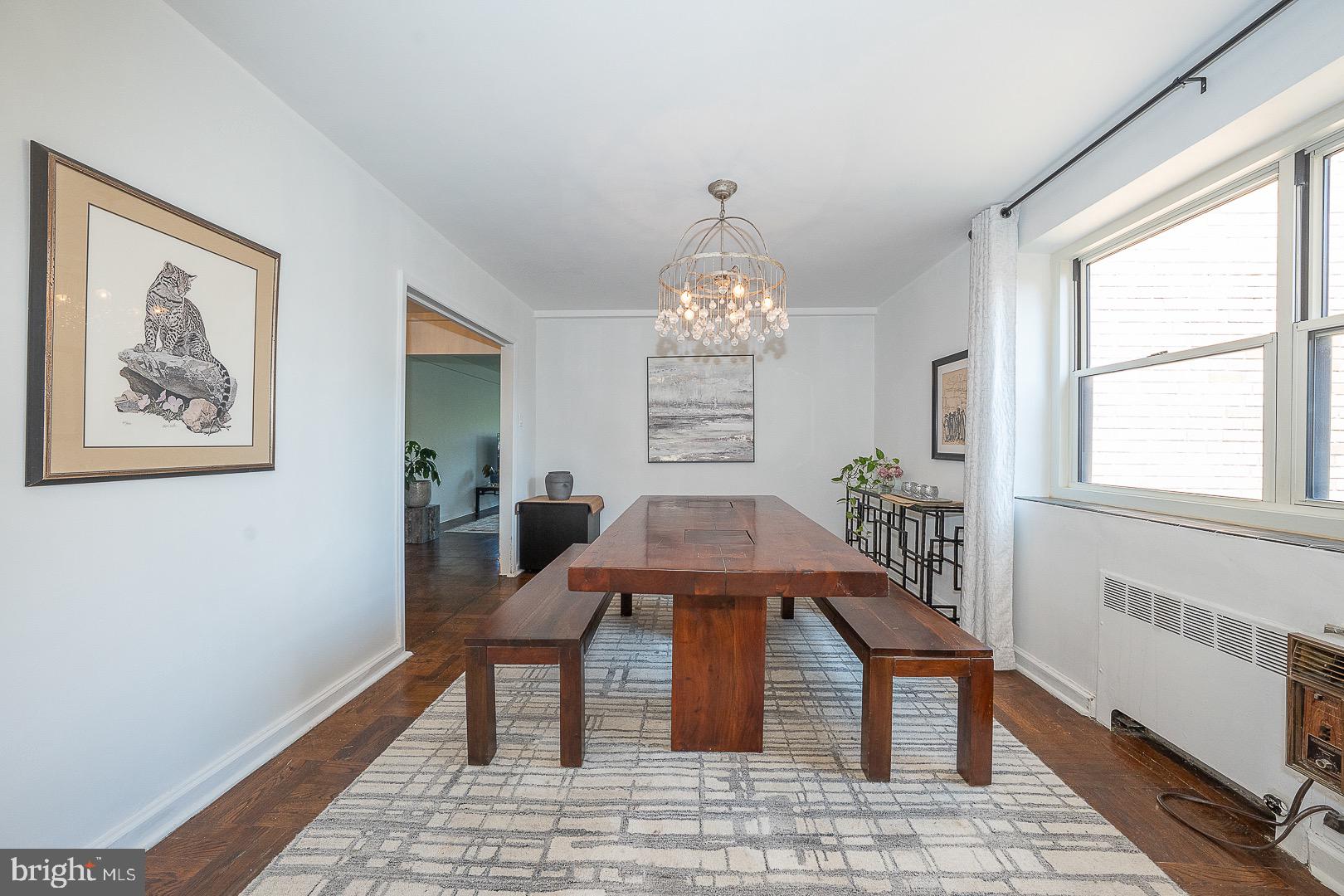 40 Old Lancaster Road, Unit 512 Merion Station, PA 19066 - Photo 17 of 60 a dining room with chandelier and wooden floor