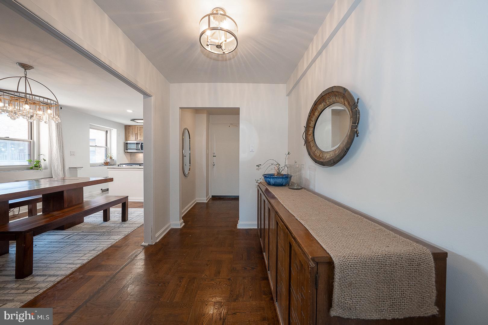 40 Old Lancaster Road, Unit 512 Merion Station, PA 19066 - Photo 18 of 60 a hallway with a large mirror on a dresser with wooden floor