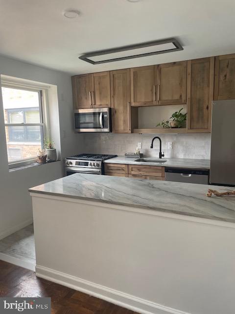 40 Old Lancaster Road, Unit 512 Merion Station, PA 19066 - Photo 2 of 60 a kitchen with stainless steel appliances granite countertop a sink a stove and a microwave oven