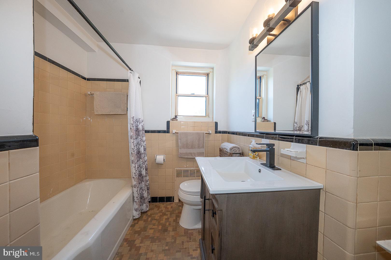 40 Old Lancaster Road, Unit 512 Merion Station, PA 19066 - Photo 26 of 60 a bathroom with a sink a mirror and a bathtub