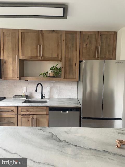 40 Old Lancaster Road, Unit 512 Merion Station, PA 19066 - Photo 3 of 60 a kitchen with stainless steel appliances granite countertop a refrigerator and a sink