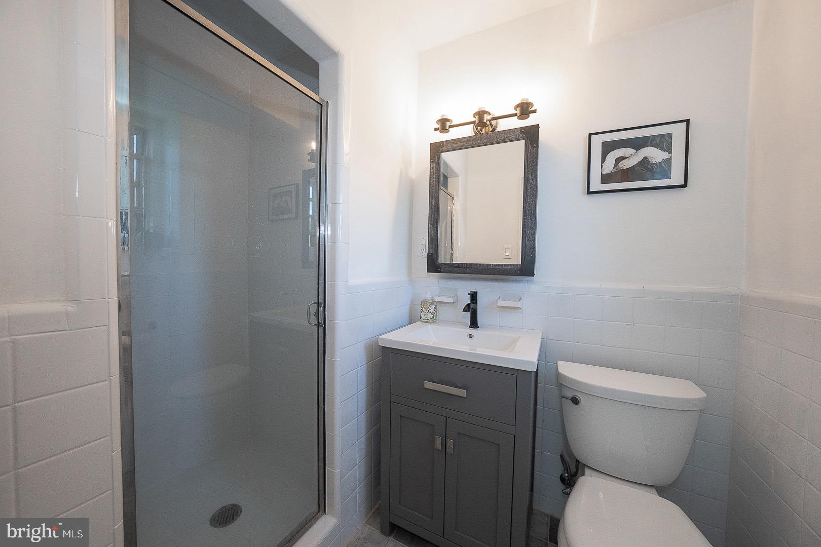 40 Old Lancaster Road, Unit 512 Merion Station, PA 19066 - Photo 31 of 60 a bathroom with a toilet a sink and mirror