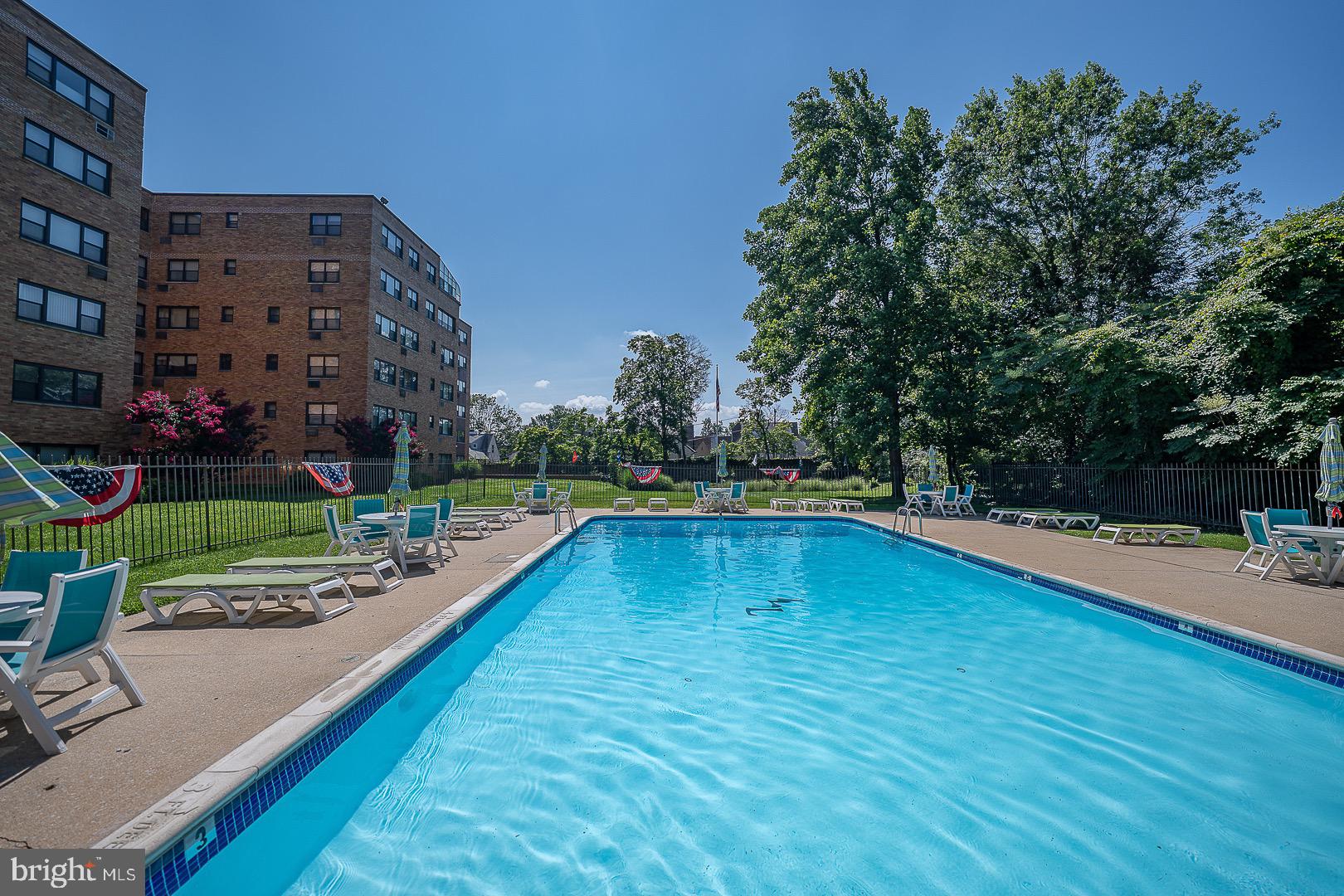 40 Old Lancaster Road, Unit 512 Merion Station, PA 19066 - Photo 46 of 60 a view of a swimming pool with a yard and sitting area