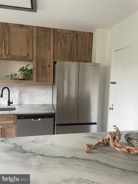 40 Old Lancaster Road, Unit 512 Merion Station, PA 19066 - Photo 5 of 60 a kitchen with granite countertop a refrigerator and a sink