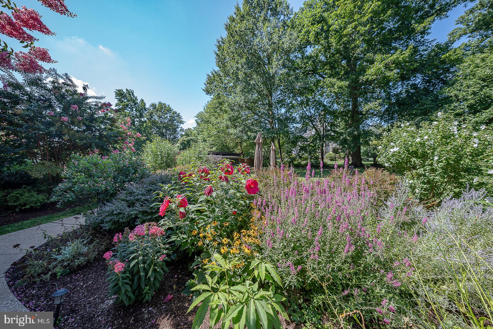 40 Old Lancaster Road, Unit 512 Merion Station, PA 19066 - Photo 51 of 60 a backyard of a house with lots of green space and trees all around