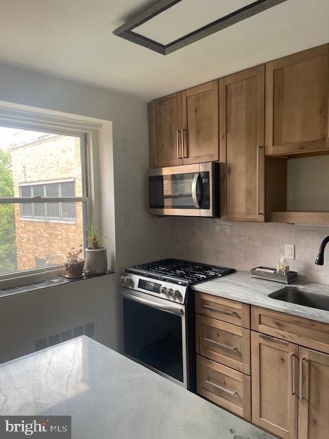40 Old Lancaster Road, Unit 512 Merion Station, PA 19066 - Photo 7 of 60 a kitchen with cabinets appliances a sink and a window