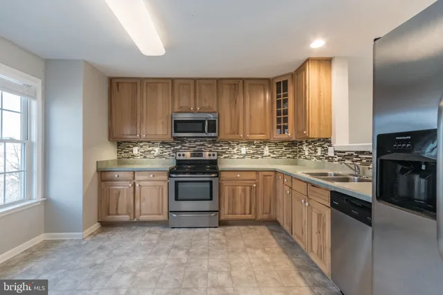 a kitchen with a sink stove and microwave