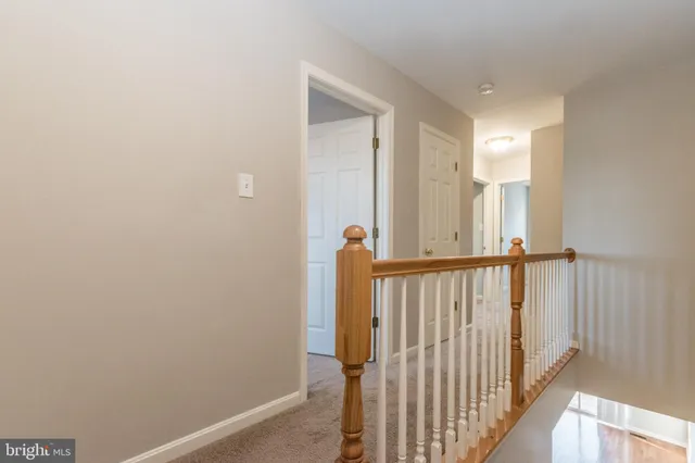 a view of a hallway with wooden floor and entryway