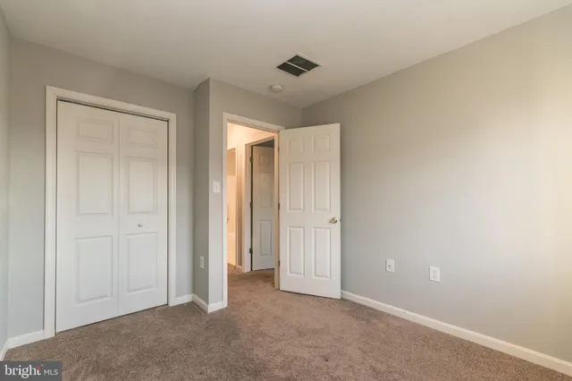 a view of an empty room and closet area