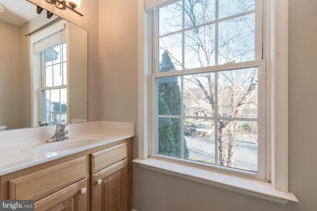 a bathroom with a sink and a window