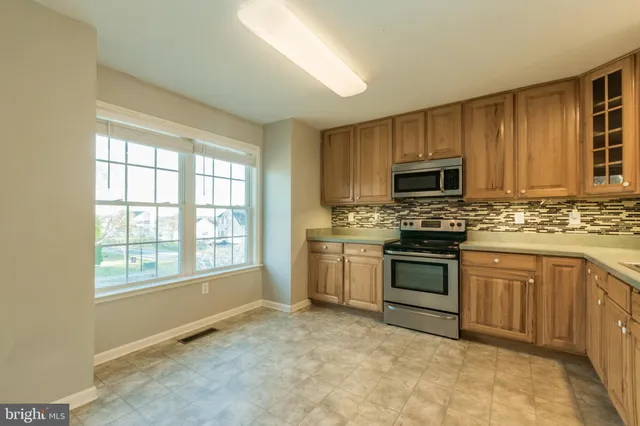 a kitchen with stove a sink and a microwave