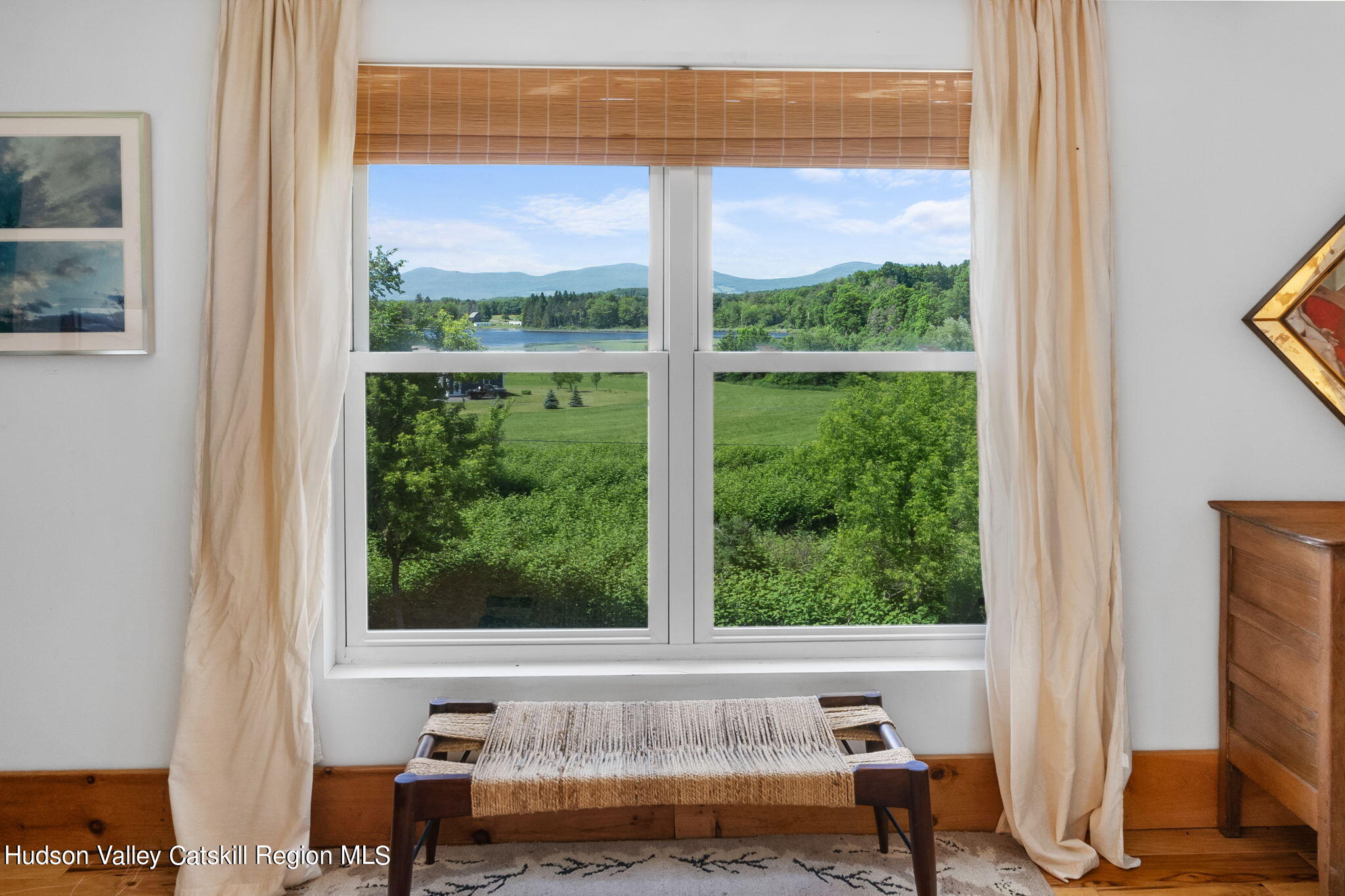 67 Jaycox Road Medusa, NY 12120 - Photo 24 of 36 a living room with a floor to ceiling window and a flat screen tv