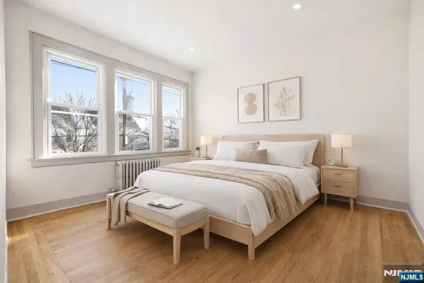 a bedroom with a bed and a large window