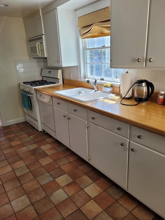 70 Craftsland Road Brookline, MA 02467 - Photo 7 of 16 a kitchen with stainless steel appliances granite countertop a sink and a stove