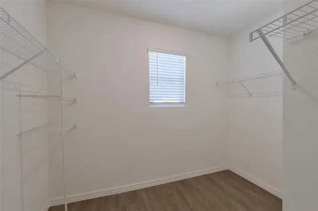 a bathroom with a granite countertop sink and white cabinets