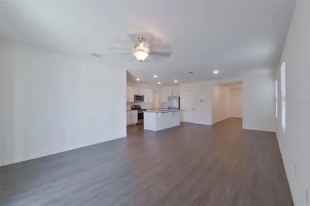 a view of a kitchen with a sink and dishwasher a refrigerator with wooden floor