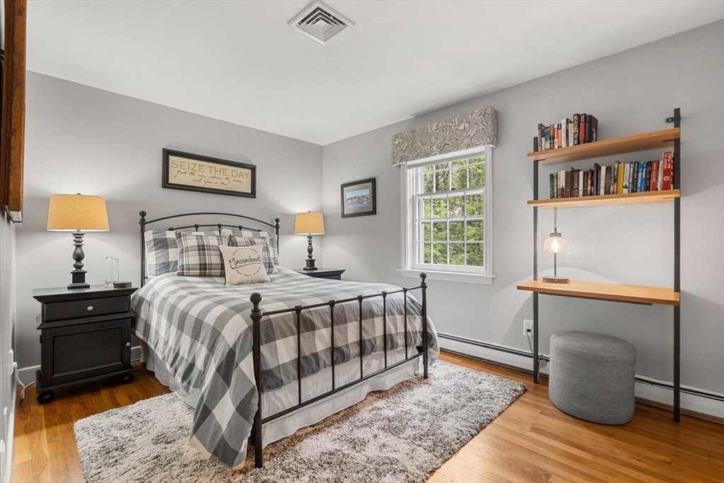 58 High Ridge Road Boxford, MA 01921 - Photo 25 of 40 a bedroom with a bed a dresser and a painting on the wall