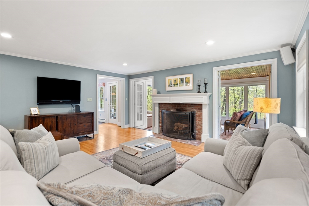 58 High Ridge Road Boxford, MA 01921 - Photo 8 of 40 a living room with furniture a flat screen tv and a fireplace