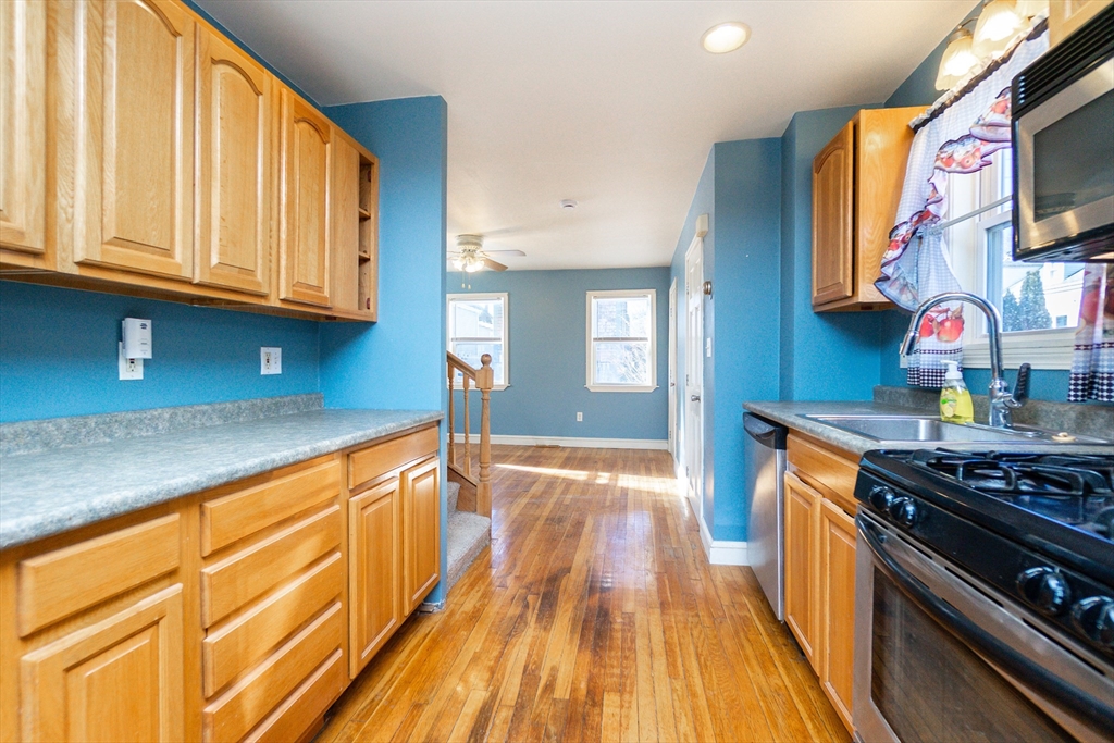 86 Flint Street Salem, MA 01970 - Photo 14 of 30 a kitchen with stainless steel appliances granite countertop a stove and a sink