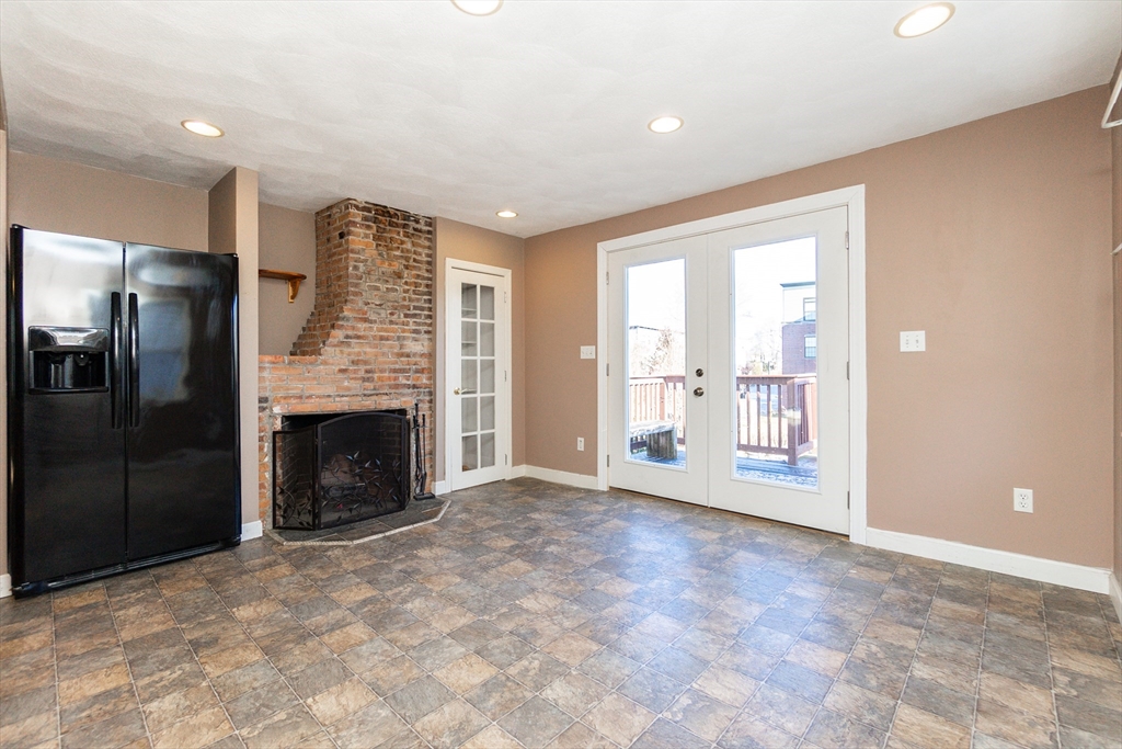 86 Flint Street Salem, MA 01970 - Photo 16 of 30 a view of an empty room with a fireplace and a window