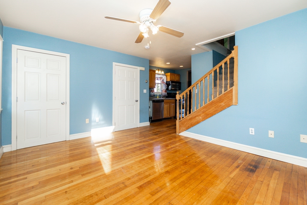 86 Flint Street Salem, MA 01970 - Photo 18 of 30 a view of a big room with wooden floor and staircase