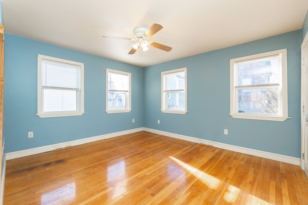 86 Flint Street Salem, MA 01970 - Photo 21 of 30 a view of a room with wooden floor and chandelier fan