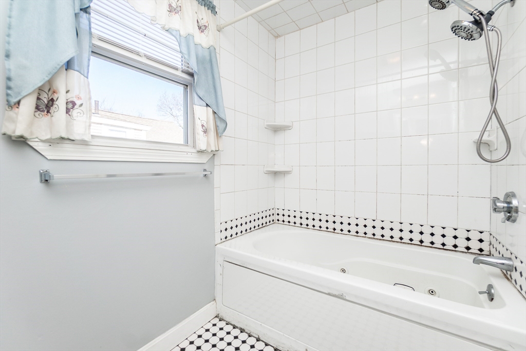 86 Flint Street Salem, MA 01970 - Photo 22 of 30 a bathroom with a bathtub and a shower