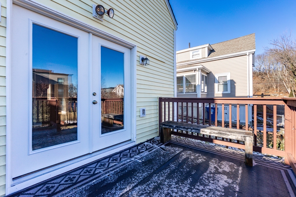 86 Flint Street Salem, MA 01970 - Photo 8 of 30 a view of a wooden house with a large window