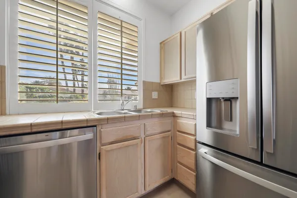 a view of a bedroom with a bed and a window