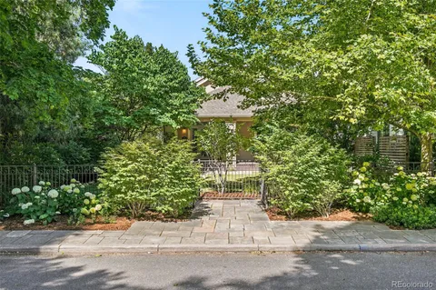 a view of a bench sitting in back yard of a house