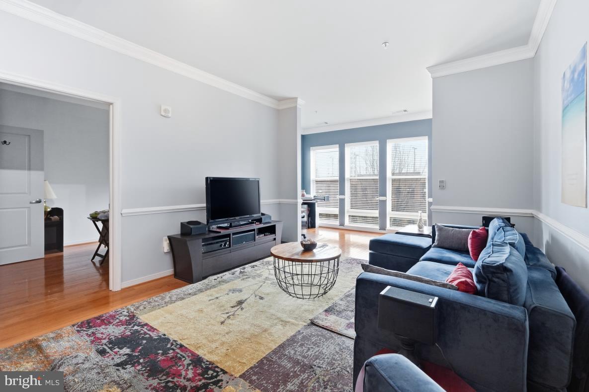 8045 Newell Street, Unit 423 Silver Spring, MD 20910 - Photo 7 of 26 a living room with furniture and a flat screen tv