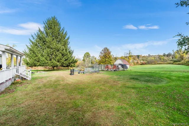a view of yard with swimming pool and trees