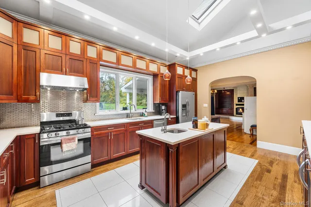 a kitchen with stainless steel appliances granite countertop a stove and a sink