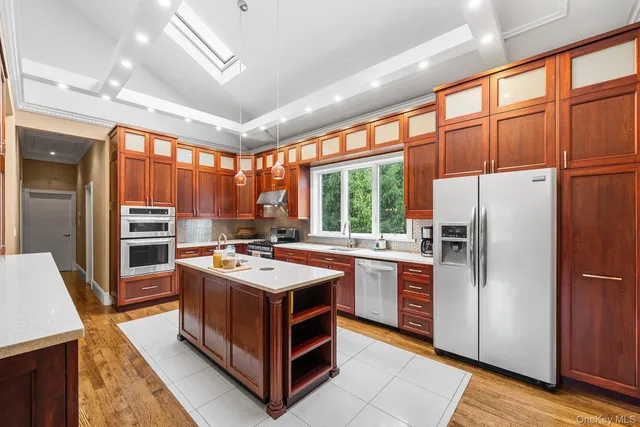 a kitchen with stainless steel appliances granite countertop a stove a refrigerator and a sink