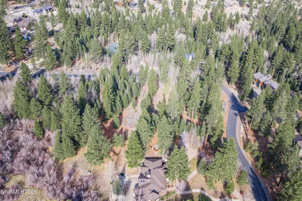 an aerial view of residential house with outdoor space and trees
