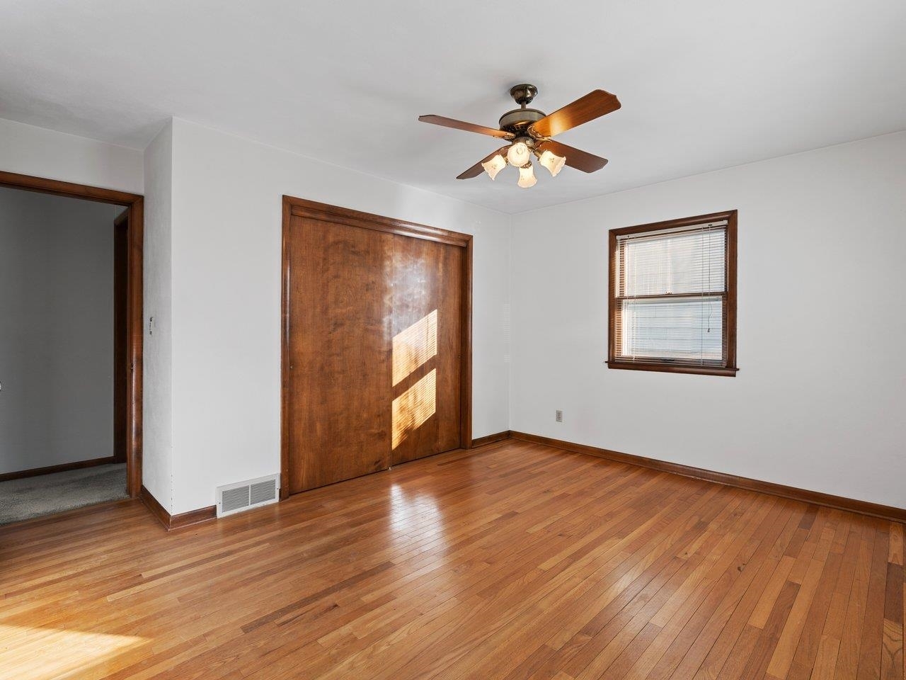 3602 14th Avenue Moline, IL 61265 - Photo 11 of 36 a view of an empty room with wooden floor and a window