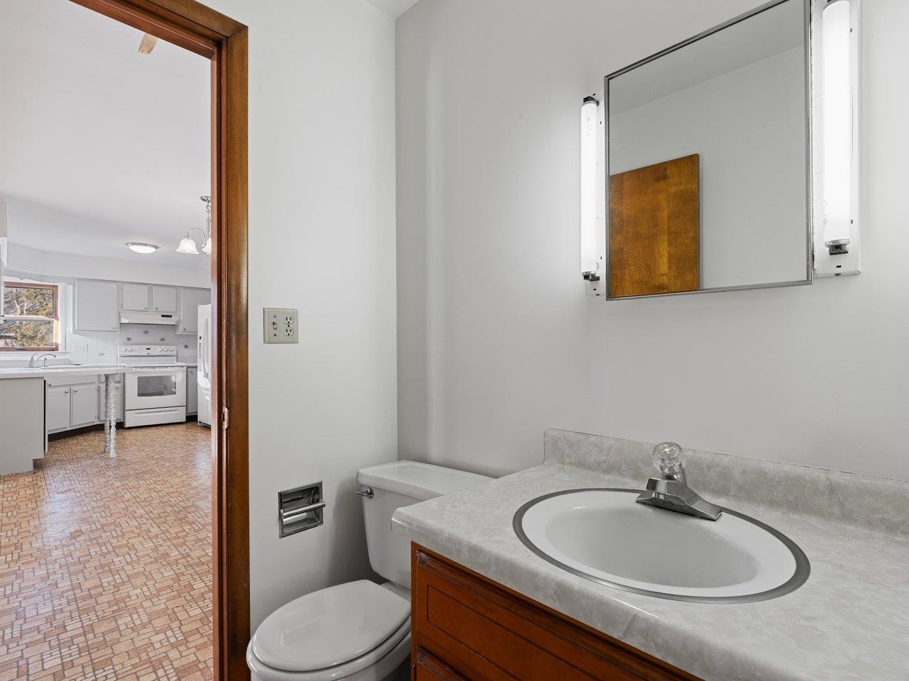 3602 14th Avenue Moline, IL 61265 - Photo 12 of 36 a bathroom with a toilet a sink and mirror
