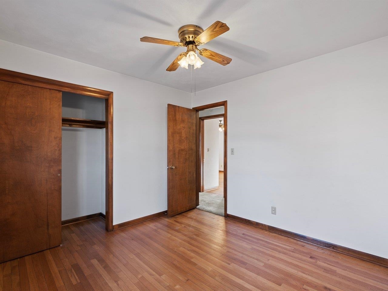 3602 14th Avenue Moline, IL 61265 - Photo 14 of 36 an empty room with wooden floor and a ceiling fan