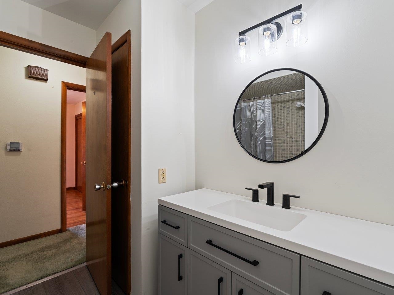 3602 14th Avenue Moline, IL 61265 - Photo 16 of 36 a bathroom with a sink and a mirror