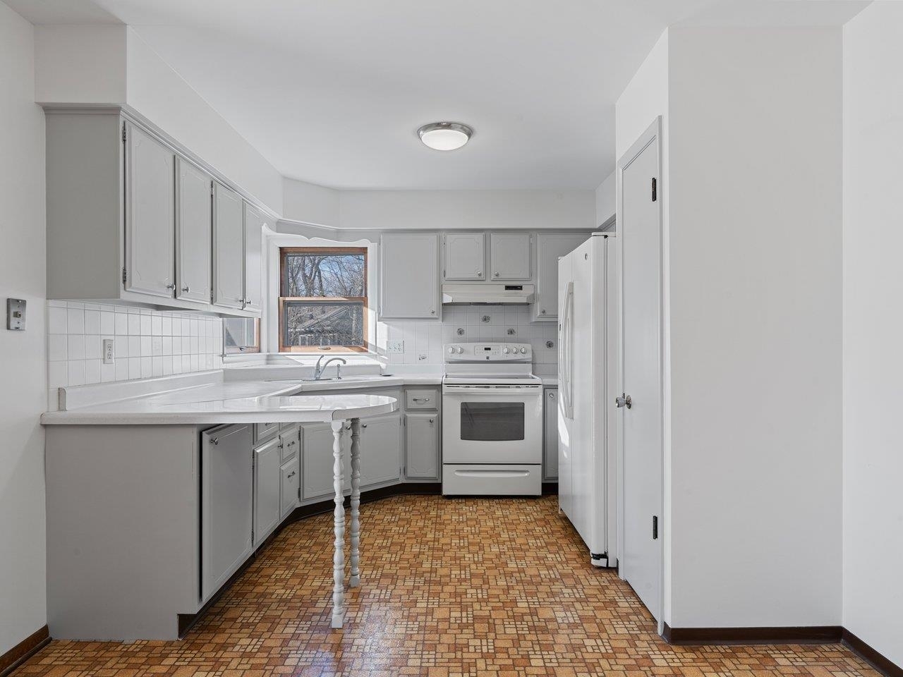 3602 14th Avenue Moline, IL 61265 - Photo 25 of 36 a kitchen with a sink stove and cabinets