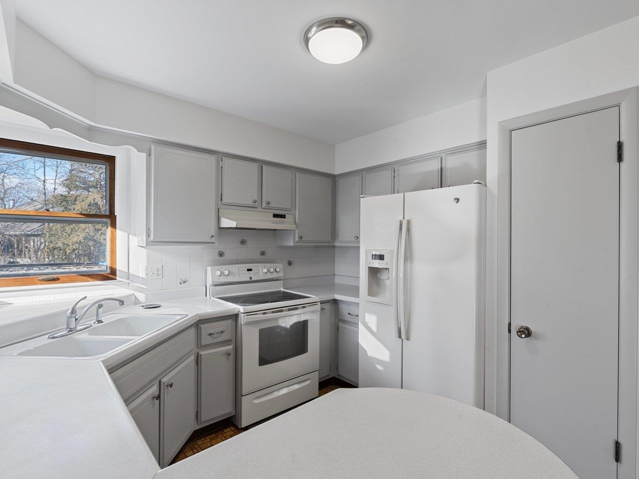 3602 14th Avenue Moline, IL 61265 - Photo 27 of 36 a kitchen with white cabinets and white appliances