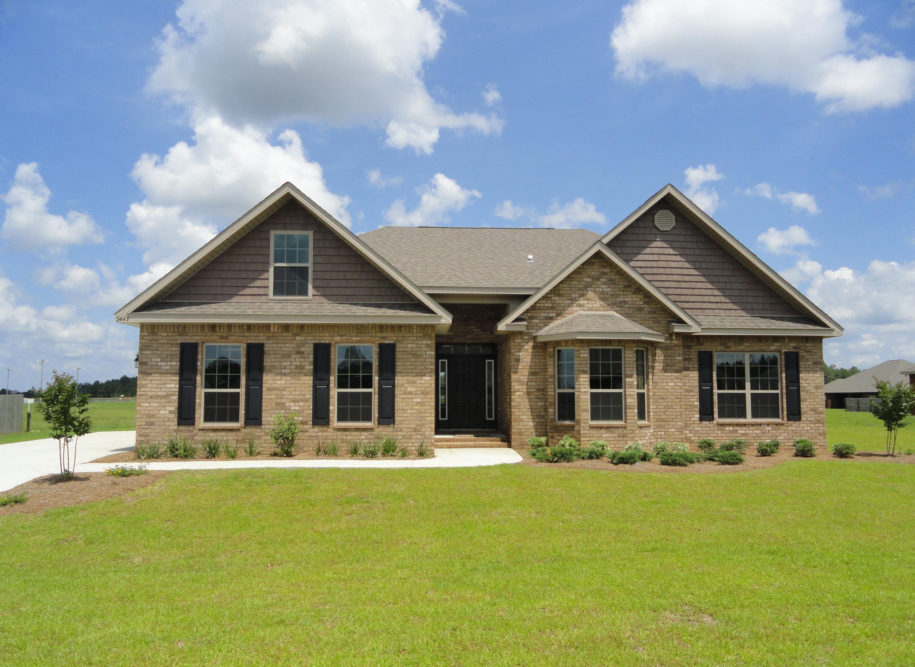 a front view of house with yard and green space