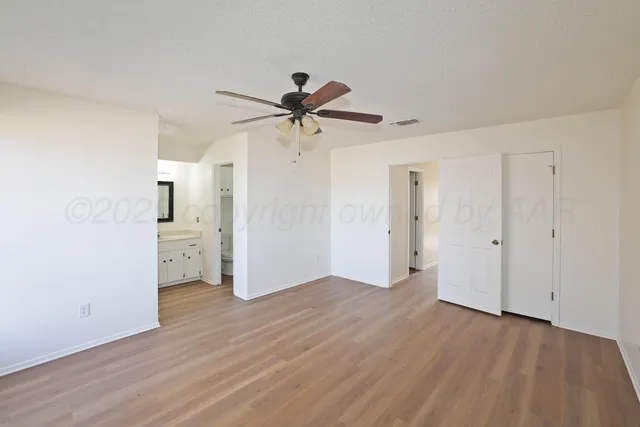 a view of a kitchen with a sink and a refrigerator