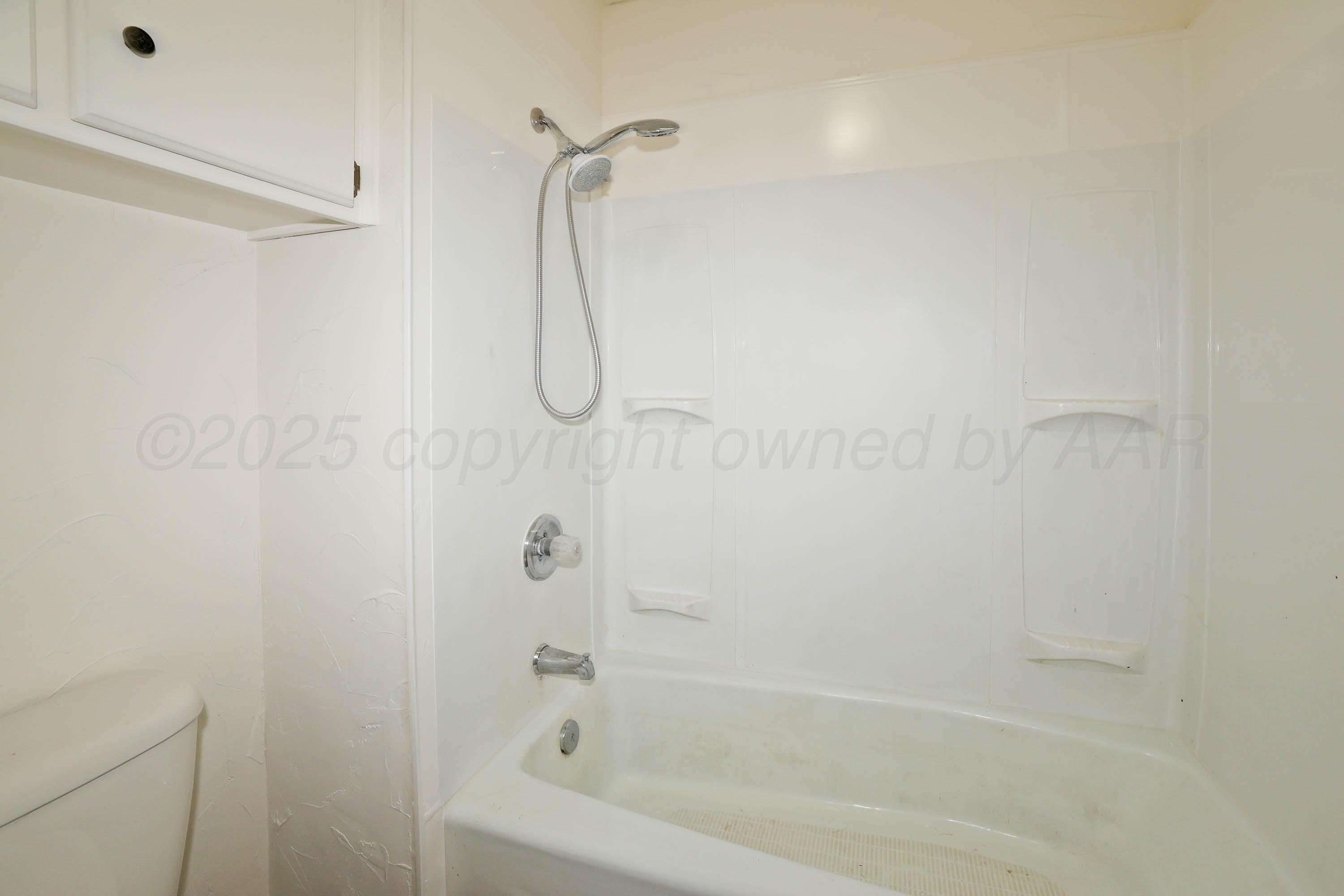 4415 Kingston Road Amarillo, TX 79109 - Photo 15 of 26 a close up of a bathtub curtain